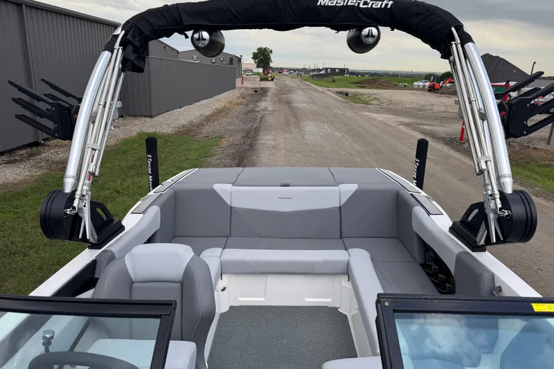 Slide: The Image of 2022 MasterCraft NXT20 boat interior with gray seating and wakeboard tower. - 11