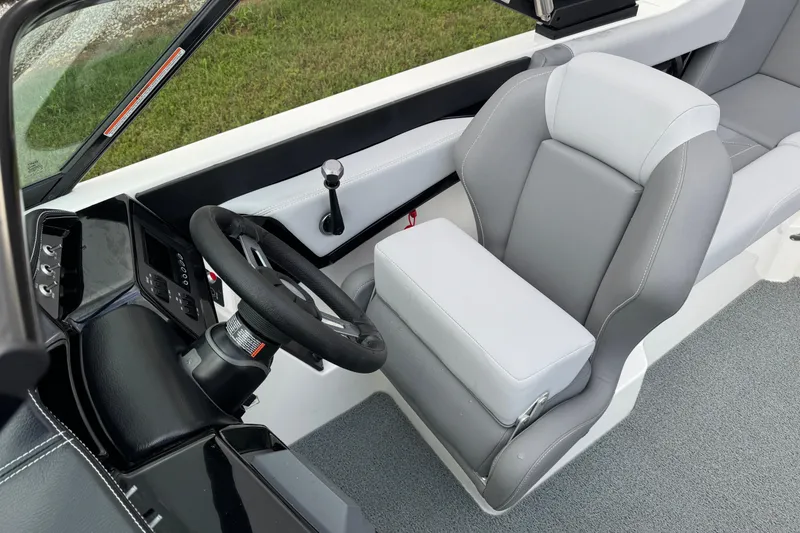 Slide: The Image of 2022 MasterCraft NXT20 boat interior with steering wheel and captain's seat. - 12