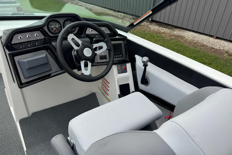 Slide: The Image of 2022 MasterCraft NXT20 boat interior with steering wheel and dashboard controls. - 13