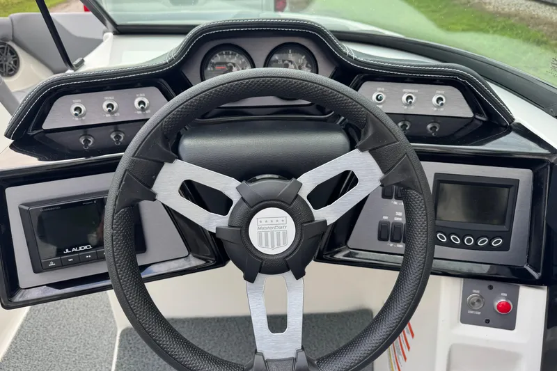 Slide: The Image of 2022 MasterCraft NXT20 dashboard with steering wheel and control panels. - 14