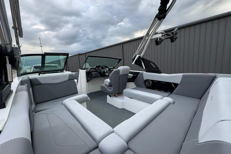Slide: The Image of 2022 MasterCraft NXT20 boat interior with gray seating and modern dashboard. - 18