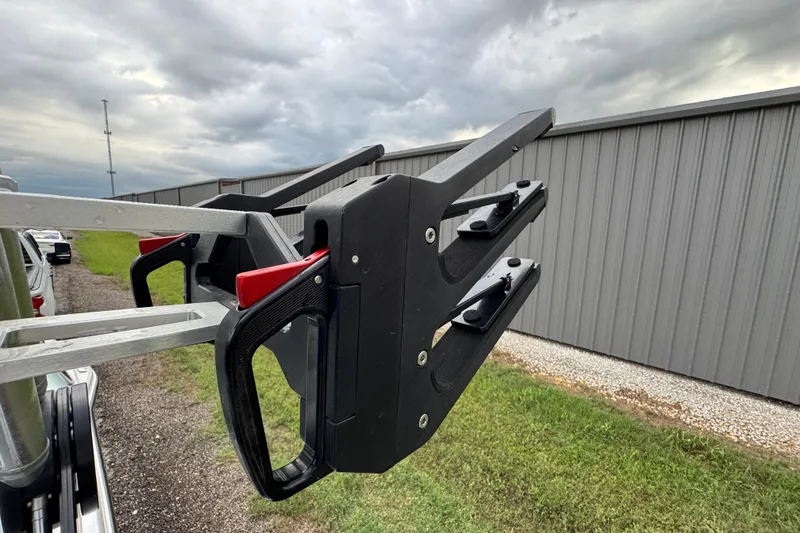 Slide: The Image of 2022 MasterCraft NXT20 boat rack with overcast sky and metal building background. - 22