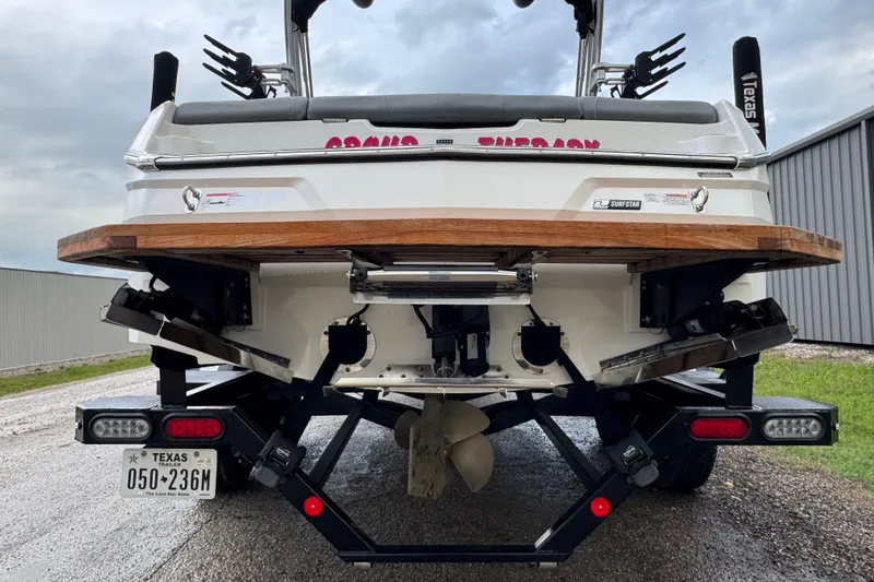 Slide: The Image of Rear view of a 2022 MasterCraft NXT20 boat on a trailer, showcasing its propeller and license plate. - 5