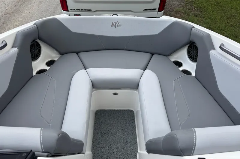 Slide: The Image of 2022 MasterCraft NXT20 boat interior with gray seating and cup holders. - 8