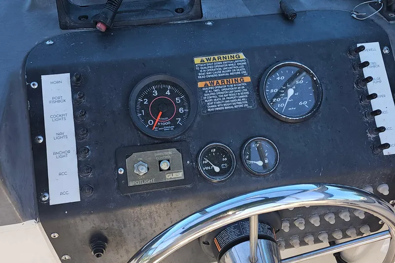 Slide: The Image of Control panel of a 2000 Bayliner Trophy boat with gauges and switches. - 5