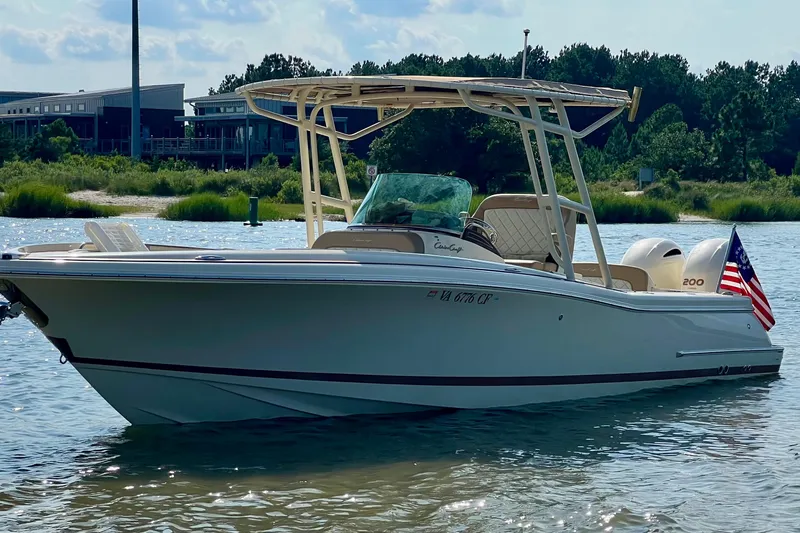 Slide: The Image of 2015 Chris-Craft Catalina 26 boat on calm water, American flag displayed. - 2