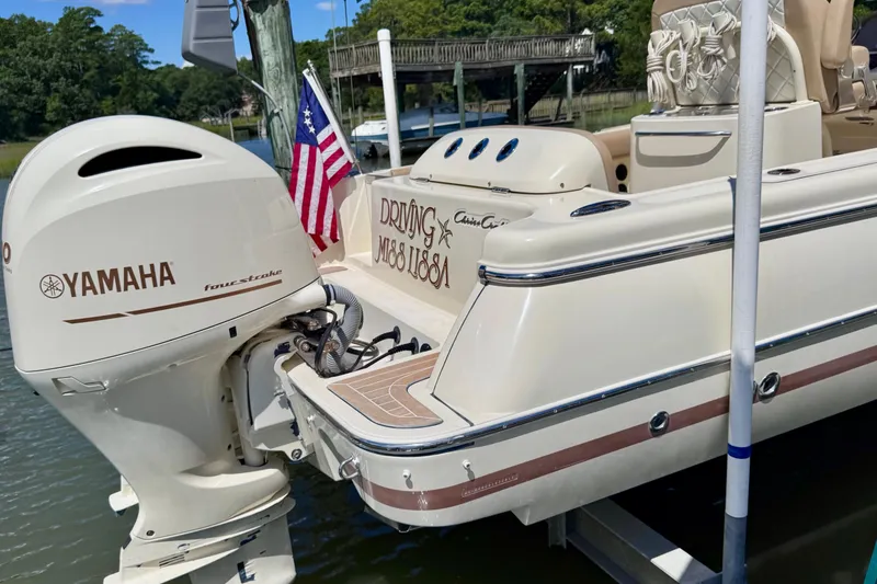 Slide: The Image of 2015 Chris-Craft Catalina 26 with Yamaha engine, docked with American flag. - 7