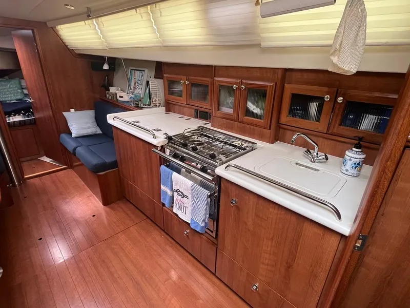 Slide: The Image of Luxurious 2016 Marlow-Hunter 31 yacht interior with wood finish and modern kitchen amenities. - 11