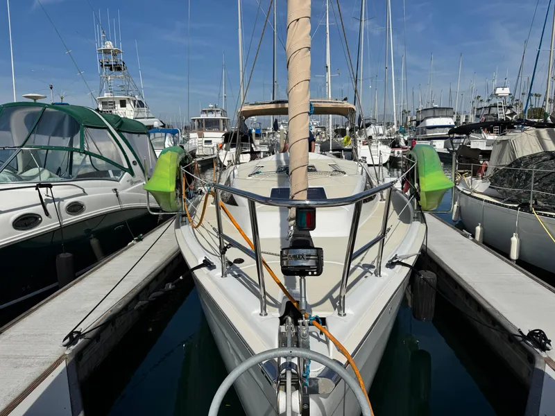 Slide: The Image of 2016 Marlow-Hunter 31 sailboat docked at marina, surrounded by other boats. - 12