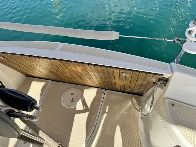 Slide: The Image of Sailboat deck of 2016 Marlow-Hunter 31 with teak flooring and railing, near water. - 16