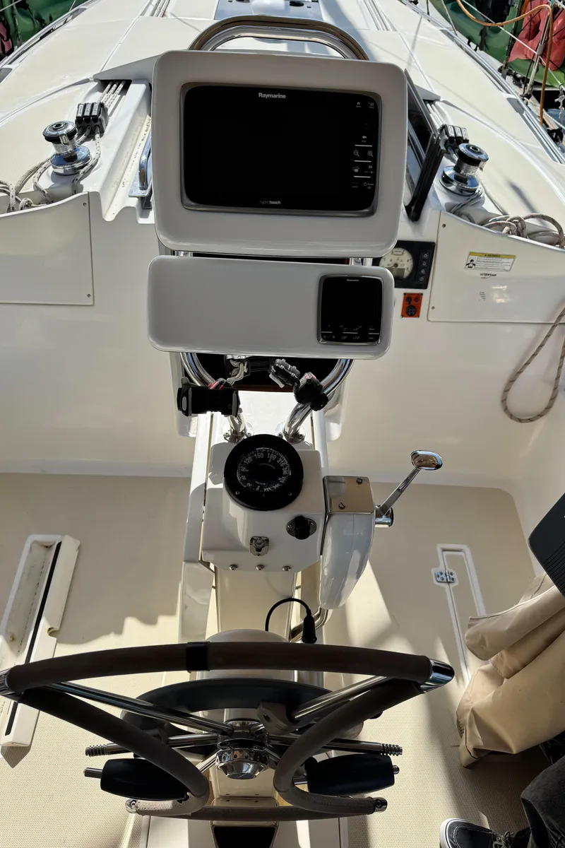 Slide: The Image of 2016 Marlow-Hunter 31 yacht helm with navigation equipment and steering wheel. - 21