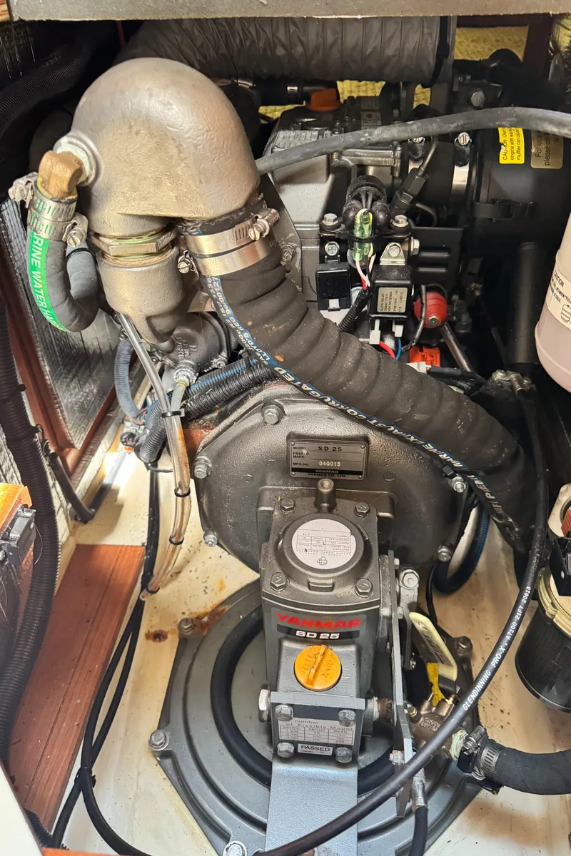 Slide: The Image of Engine compartment of a 2016 Marlow-Hunter 31 sailboat, showcasing mechanical components. - 22