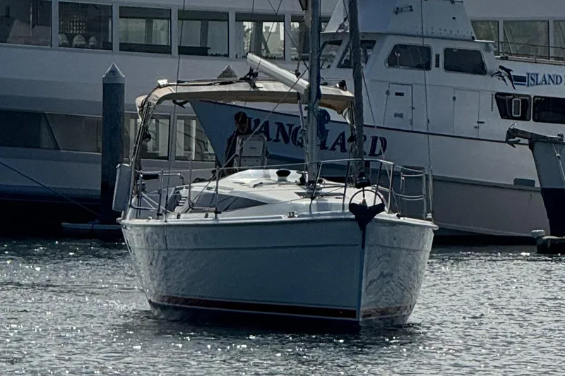 Slide: The Image of 2016 Marlow-Hunter 31 sailboat docked in a marina, surrounded by other vessels. - 24