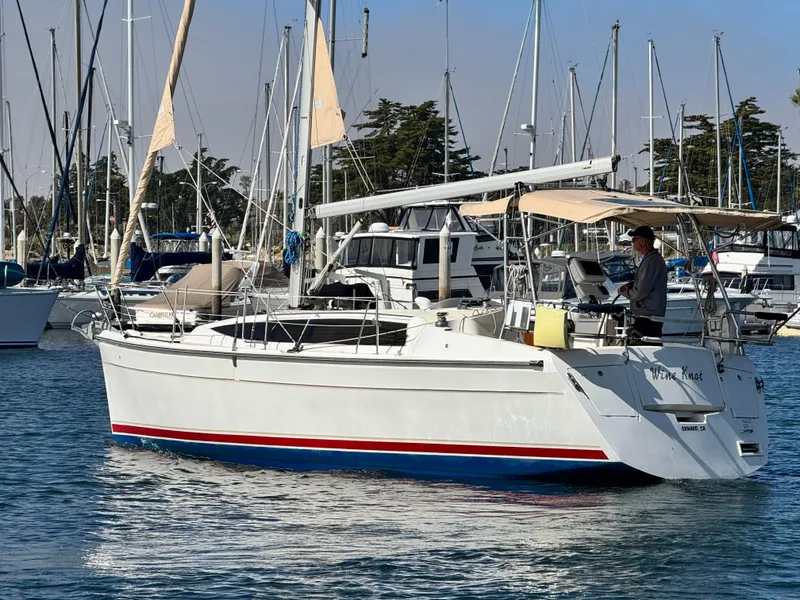 Slide: The Image of 2016 Marlow-Hunter 31 sailboat docked in a marina, with a person on deck. - 4