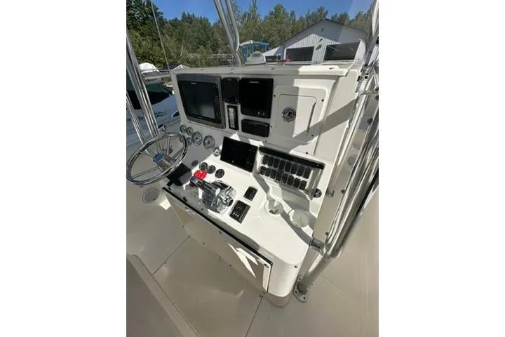 Slide: The Image of 2005 Marlago 35 SS boat dashboard with steering wheel and control panel. - 11