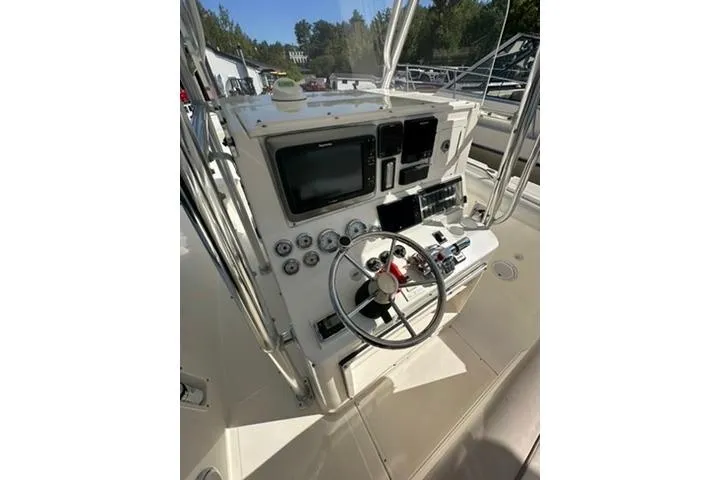 Slide: The Image of 2005 Marlago 35 SS boat dashboard with steering wheel and navigation instruments. - 12