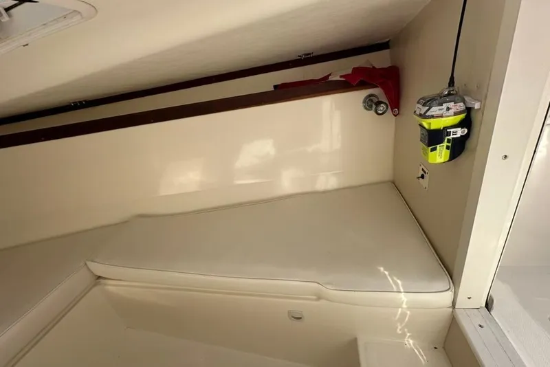 Slide: The Image of Interior cabin of a 2005 Marlago 35 SS boat, featuring a cushioned seating area. - 16