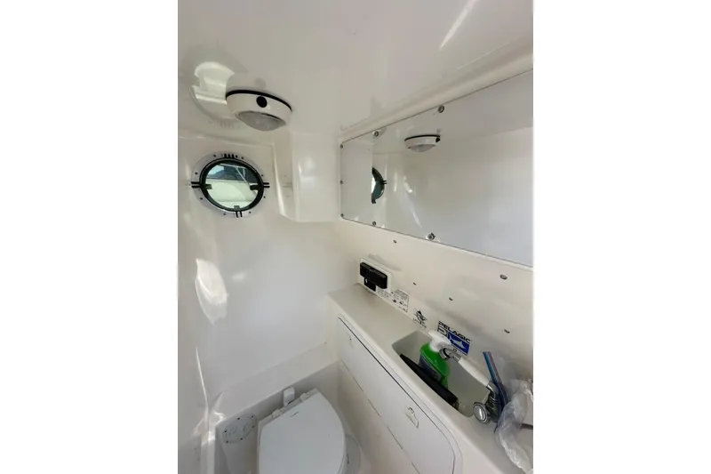 Slide: The Image of 2005 Marlago 35 SS boat interior with porthole, sink, and toilet. - 18