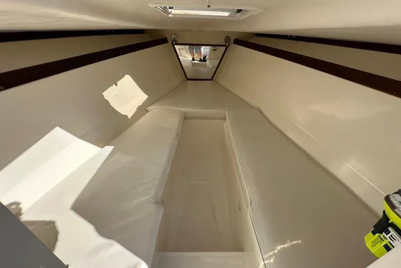 Slide: The Image of 2005 Marlago 35 SS boat interior cabin with white seating and natural light. - 21