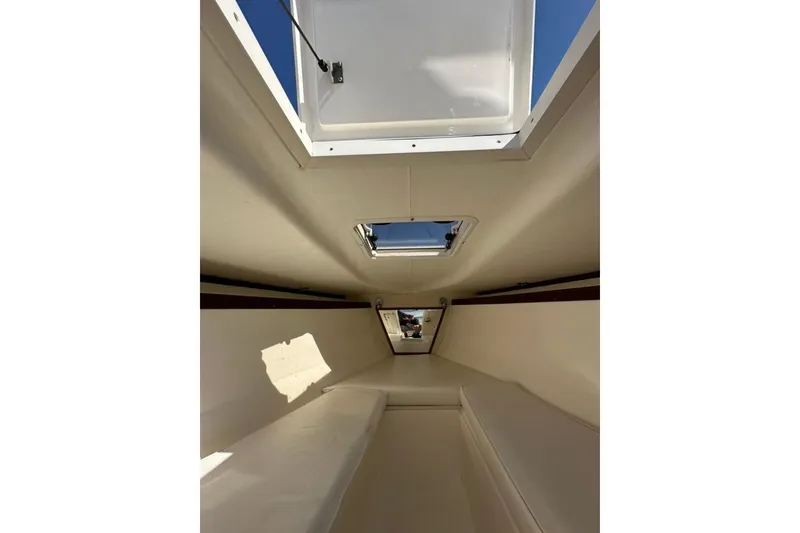 Slide: The Image of Interior view of a 2005 Marlago 35 SS boat cabin with open hatches. - 23