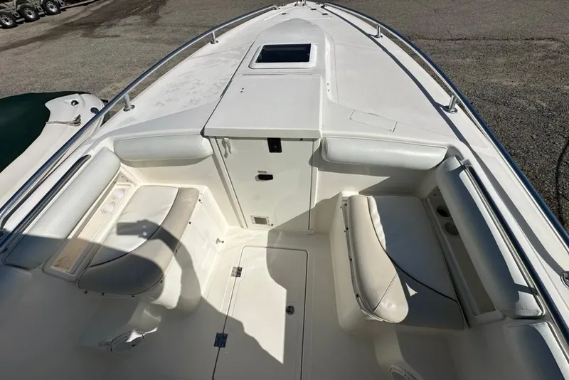Slide: The Image of 2005 Marlago 35 SS boat interior with white seating and storage compartments. - 25