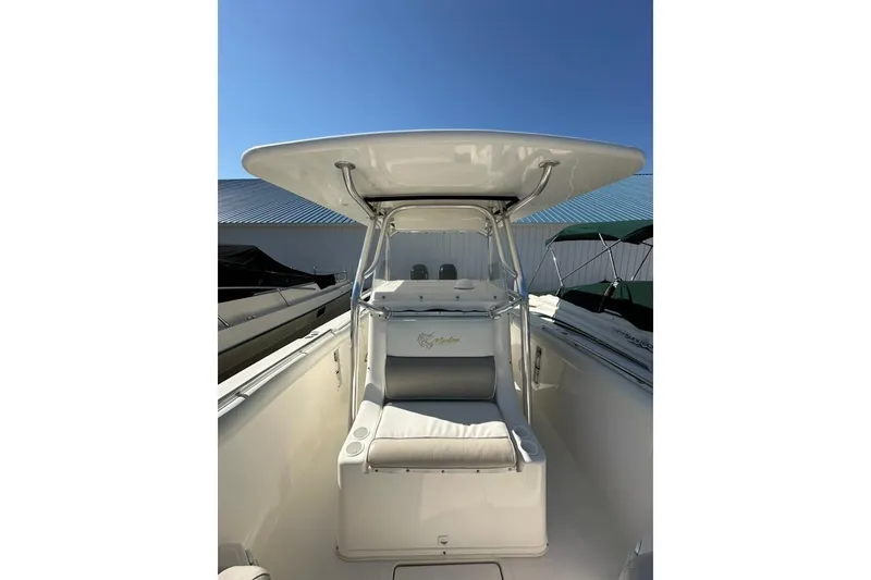 Slide: The Image of 2005 Marlago 35 SS boat interior with seating and canopy under clear blue sky. - 26