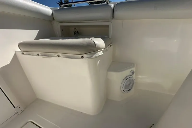 Slide: The Image of 2005 Marlago 35 SS boat interior with cushioned seating and speaker. - 28
