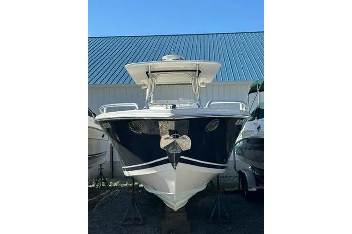 Slide: The Image of 2005 Marlago 35 SS boat with blue hull, docked outdoors. - 3