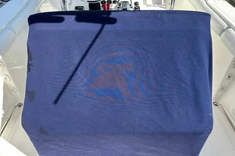 Slide: The Image of 2005 Marlago 35 SS boat with blue cover and visible controls. - 31