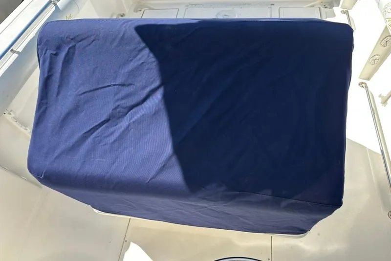 Slide: The Image of Covered console on a 2005 Marlago 35 SS boat, featuring a blue fabric cover. - 32