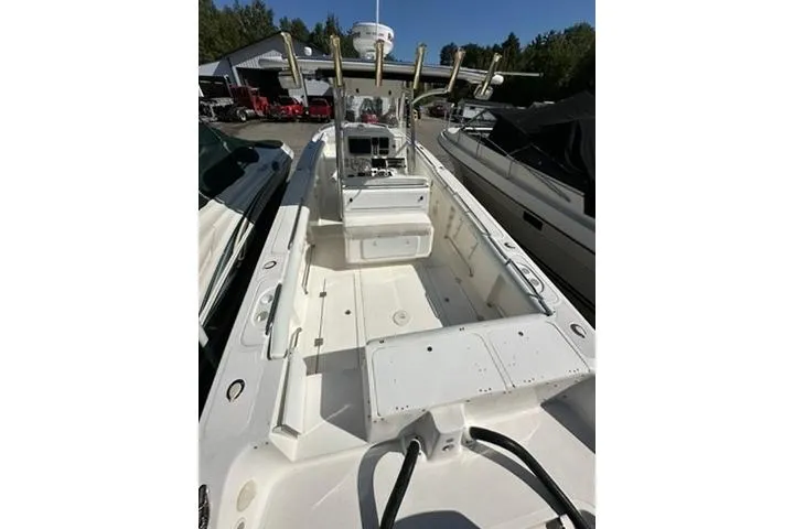 Slide: The Image of 2005 Marlago 35 SS boat with spacious deck and fishing rod holders. - 6
