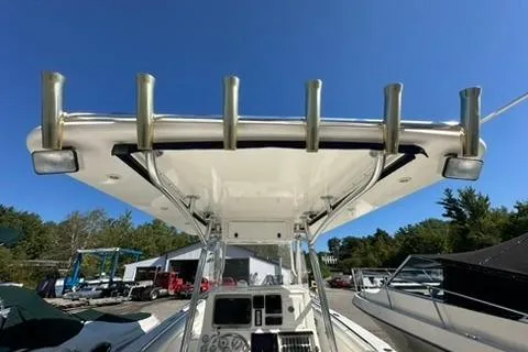 Slide: The Image of 2005 Marlago 35 SS boat with T-top and rod holders, docked under clear blue sky. - 8