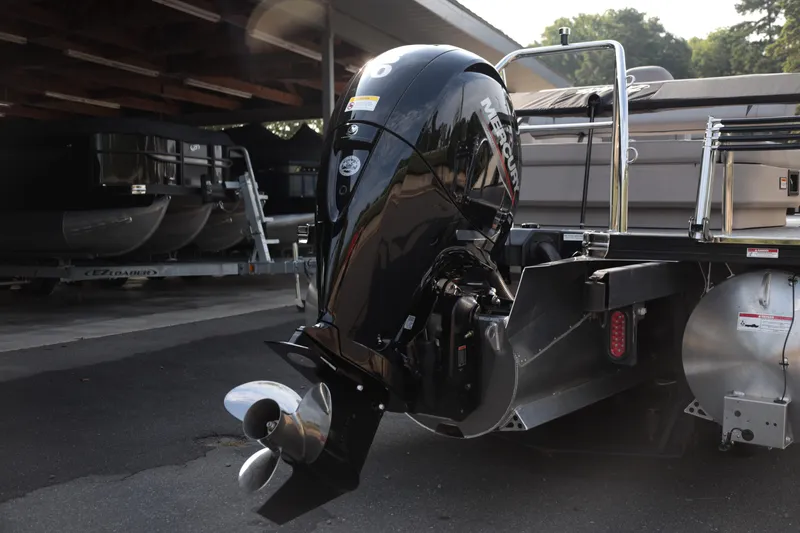 Slide: The Image of 2026 Barletta ARIA 22UC pontoon boat with Mercury outboard motor in a storage area. - 16