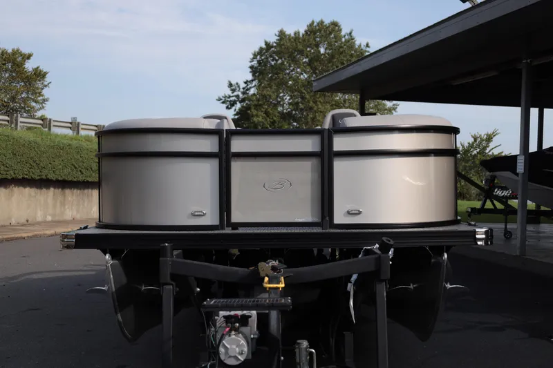 Slide: The Image of 2026 Barletta ARIA 22UC pontoon boat on trailer, parked outdoors. - 2