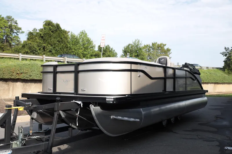 Slide: The Image of 2026 Barletta ARIA 22UC pontoon boat on trailer, parked outdoors. - 3
