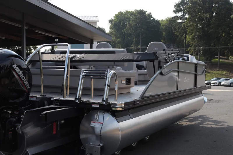 Slide: The Image of 2026 Barletta ARIA 22UC pontoon boat with Mercury engine, parked outdoors. - 6