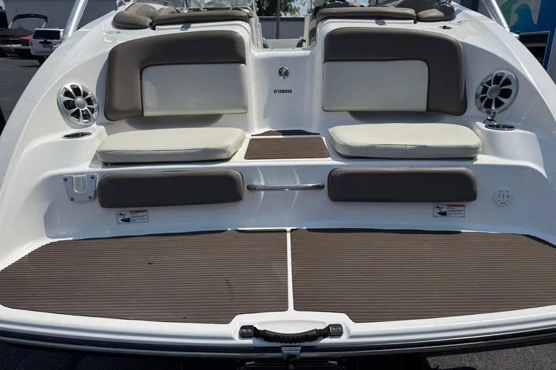 Slide: The Image of 2012 Yamaha Boats 242 Limited S swim platform with cushioned seating and speakers. - 11