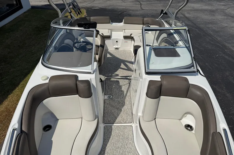Slide: The Image of 2012 Yamaha Boats 242 Limited S interior with seating and open windshield. - 14