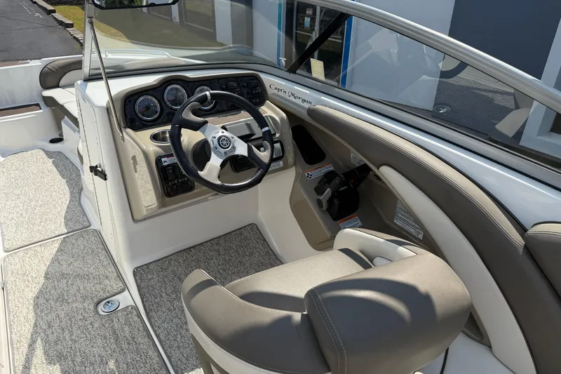 Slide: The Image of 2012 Yamaha Boats 242 Limited S cockpit with steering wheel and dashboard controls. - 22