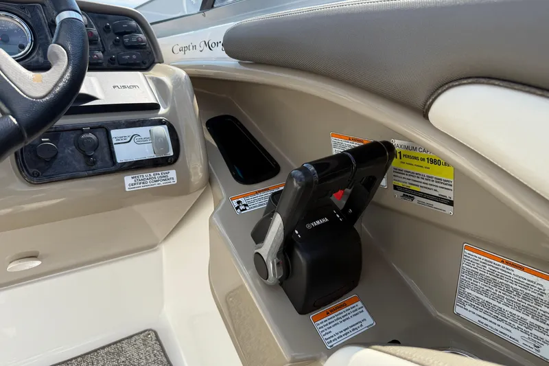 Slide: The Image of 2012 Yamaha Boats 242 Limited S dashboard and controls, featuring steering wheel and throttle. - 23