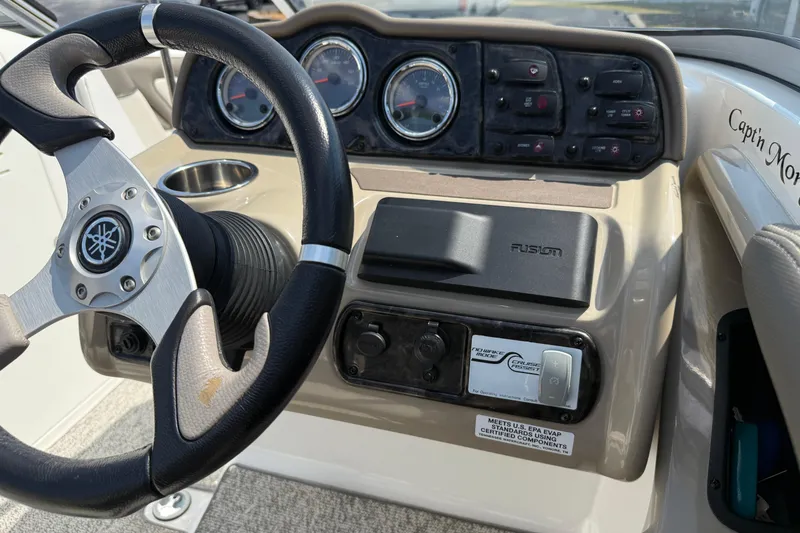 Slide: The Image of 2012 Yamaha Boats 242 Limited S dashboard with steering wheel and controls. - 25