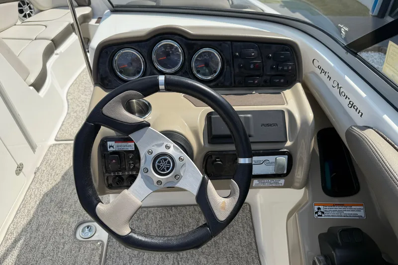 Slide: The Image of Steering console of 2012 Yamaha Boats 242 Limited S with gauges and controls. - 26