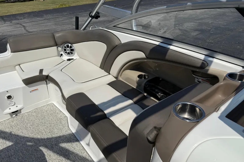 Slide: The Image of 2012 Yamaha Boats 242 Limited S interior seating with cup holders and speaker. - 28