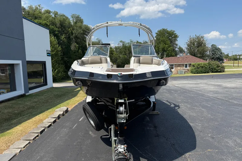 Slide: The Image of 2012 Yamaha Boats 242 Limited S on trailer, parked outdoors under clear sky. - 3