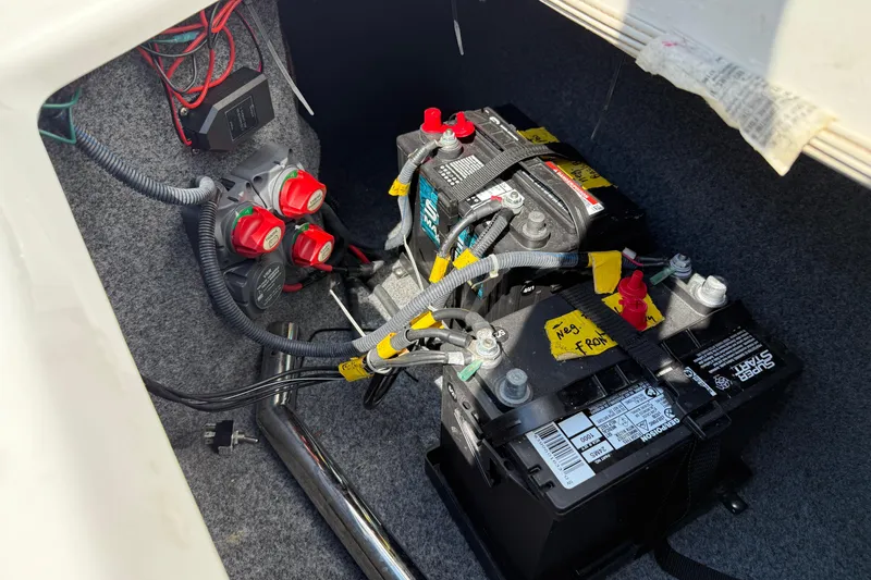 Slide: The Image of Battery compartment of a 2012 Yamaha Boats 242 Limited S with wiring and switches. - 32