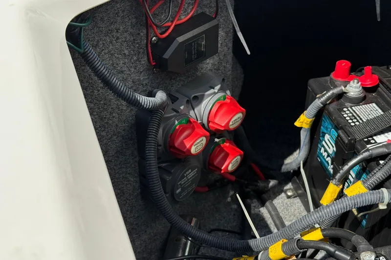Slide: The Image of Battery compartment of a 2012 Yamaha Boats 242 Limited S with wiring and switches. - 33