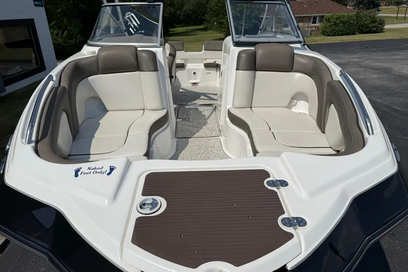 Slide: The Image of 2012 Yamaha Boats 242 Limited S interior with cushioned seating and "Naked Foot Only" sign. - 5