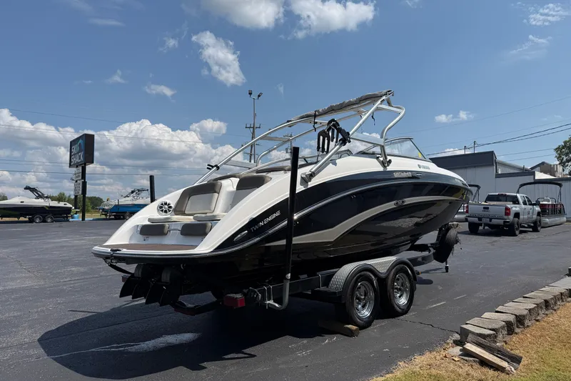 Slide: The Image of 2012 Yamaha Boats 242 Limited S on trailer, parked outdoors under a clear sky. - 8