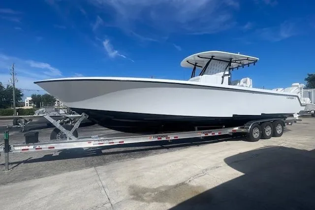 The Image of 2026 Contender 39 ST boat on trailer under clear blue sky. - 1