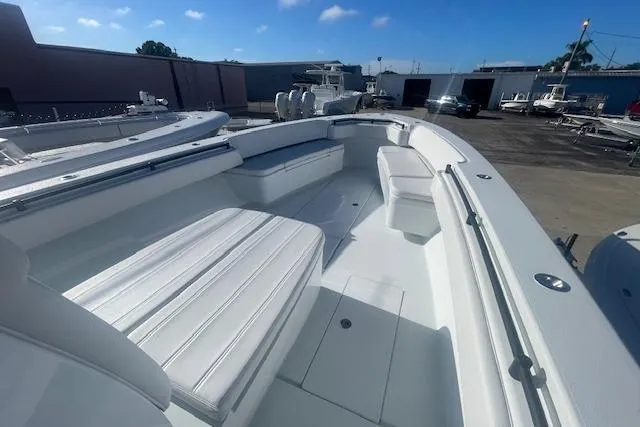 Slide: The Image of 2026 Contender 39 ST boat with spacious seating, docked outdoors under a clear sky. - 14